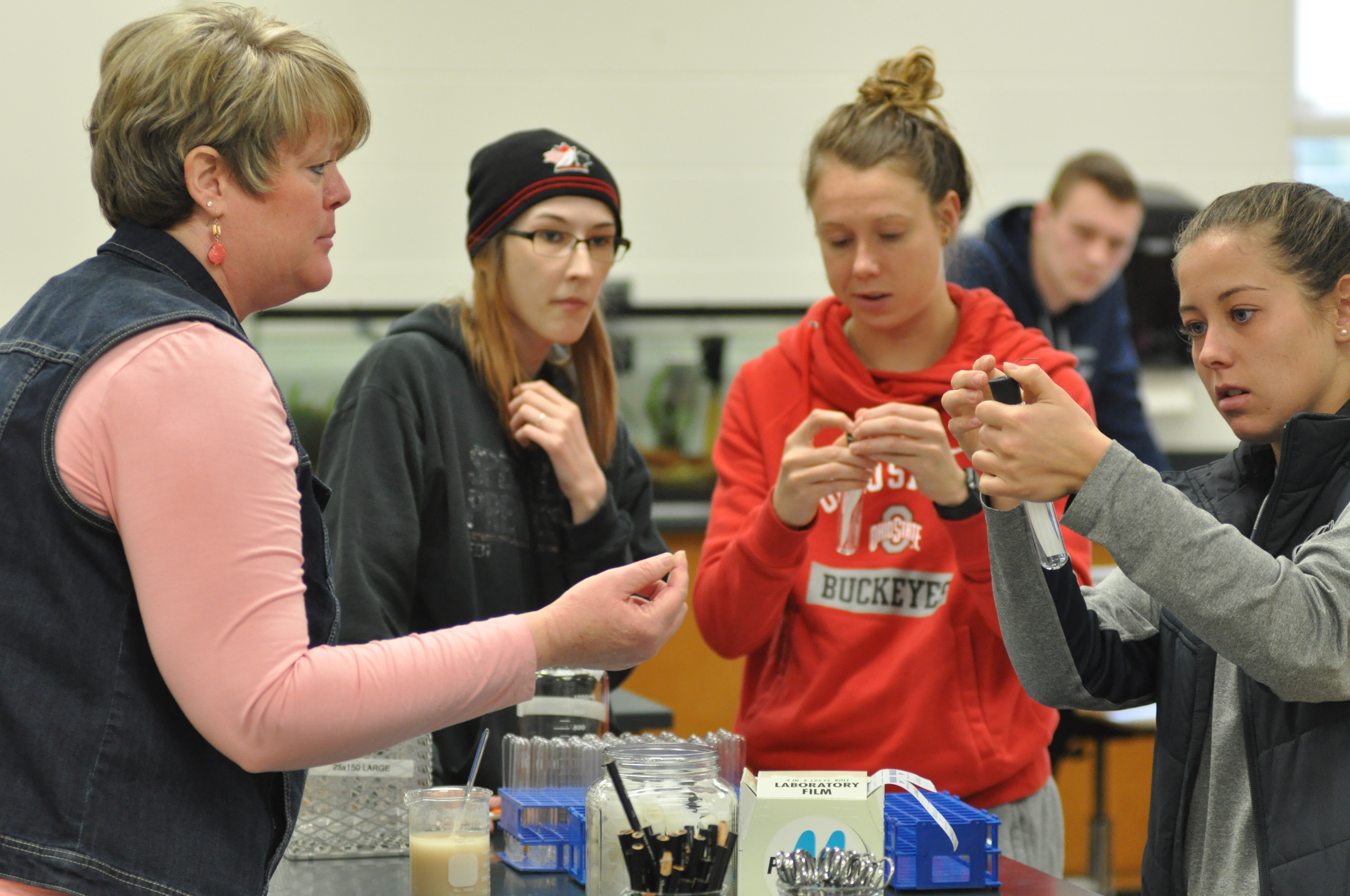 Faculty and students working on a lab.