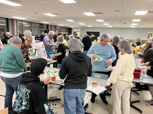 People helping pack food for those in need.