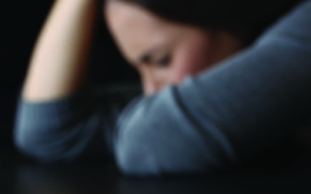 Woman with head down on table