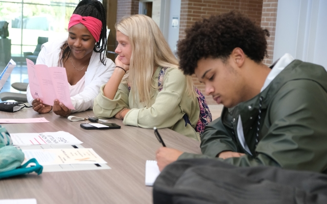 Students working at table in Founders Hall.